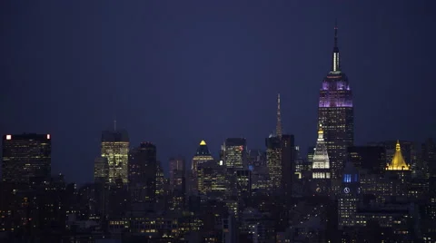 Flying by Midtown Manhattan at night; Manhattan Bridge goes close through frame, Stock Footage 59171647