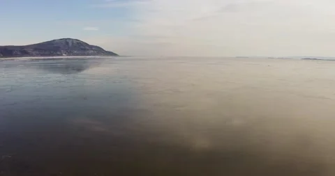Flying mirror river with mountain in background from drone Stock Footage 151863099