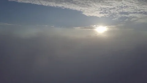 Flying into misty clouds during sunrise. Stock Footage 80014420