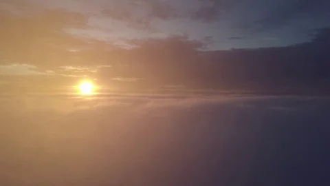 Flying in misty clouds during sunrise. Stock Footage 80015045