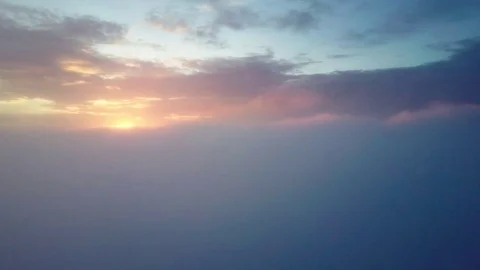 Flying in misty clouds during sunrise. Stock Footage 80015619