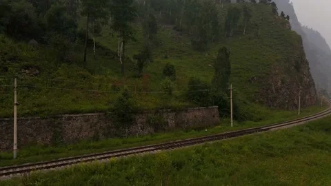 Flying in the mountains from the bottom up over the railway. Stock Footage 158968993
