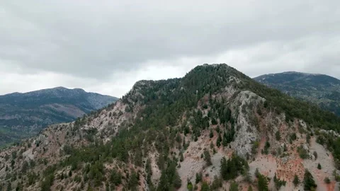 Flying in the mountains in cloudy weather 4k Video stock 213606347