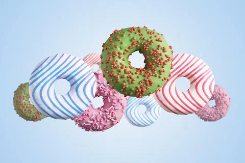 Flying multicolored donuts on a blue background. Stock Photos