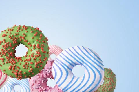 Flying multicolored donuts on a blue background. Foto stock