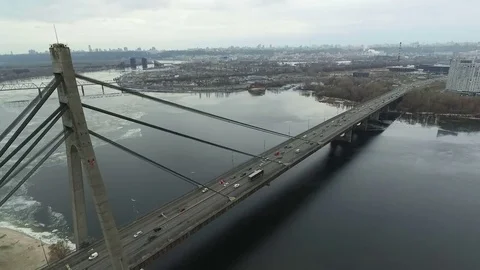 Flying near the bridge over the river. The camera is moving away backward. Stock-Footage 70852360