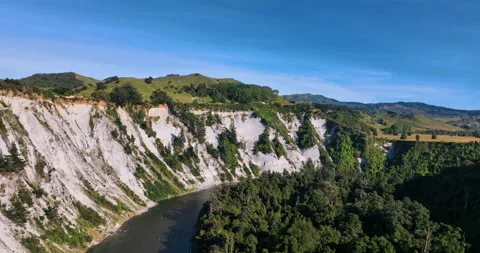 Flying next to rugged cliff face Mangaweka Rangitikie river - New Zealand Stock Footage 171863750