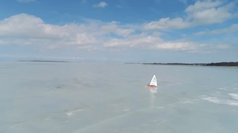Flying next to a speeding ice boat on frozen sea Stock Footage 88201071