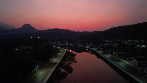 Flying at night over the parrot river in the city of Santo Antonio with the red Stock-Footage 312026596
