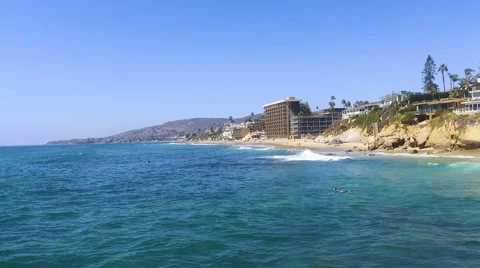 Flying North above the waves in Main Beach, Laguna Beach, Southern California Stock Footage 67444018