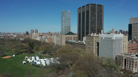 Flying north tilting down on tent Hospital in New York Central Park Covid Stock Footage 127878352