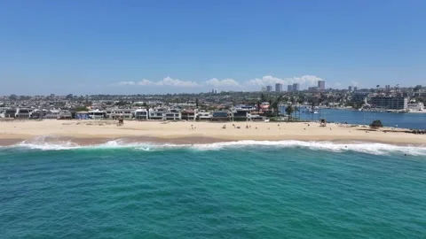 Flying northbound along Balboa Beach located on Harbor Island Stock Footage 340075540