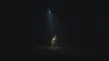 The flying object shines bright light on a man on the dark background 4k or 4k+ Resolution