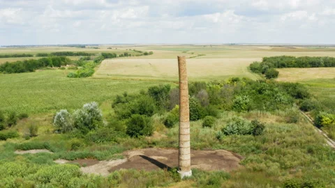 Flying by an old brick chimney in the middle of the field Видео 137720267