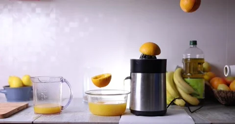 Flying oranges producing their own orange juice in a magic kitchen Stock Footage 169410253