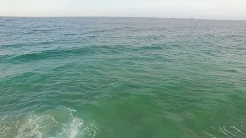 Flying out into the ocean from the beach Stock Footage 83530097