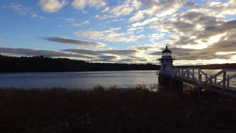 Flying Out Over a River Beside a Lighthouse Stock Footage 97545227