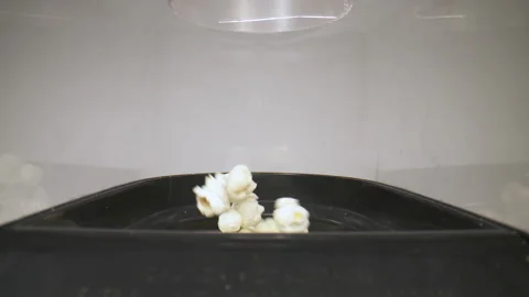 Flying out of a popcorn machine Stock Footage 130835601
