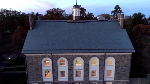 Flying out through white arch window on historic church school building Stock Footage 241833599