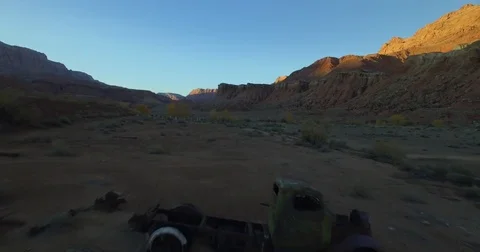 Flying over abandoned truck in the desert sunset Stock Footage 81045853