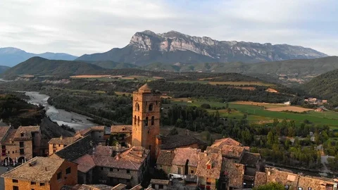 Flying over Ainsa, Spain with mountains Pena Montanesa in the background during 스톡 동영상 100286575