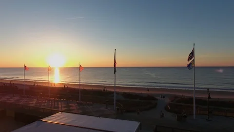 Flying over American flags in Myrtle Beach at Sunrise along the shore Stock Footage 121663128