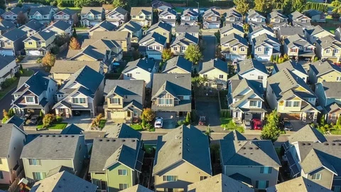 Flying over an American suburban neighborhood with small craftsman style houses Stock Footage