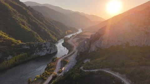 Flying Over Ancient Castle Ruins Toward Golden Sunset and River Video stock 337359858