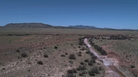 Flying over an arroyoa in the desert Stock-Footage 79238655