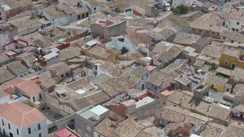 Flying over Atalaya, with its medieval rooftops, narrow streets, and a sun-.. Video stock 282708715