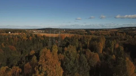 Flying over autumn forest towards transmission tower and fields. Stock Footage 81213771