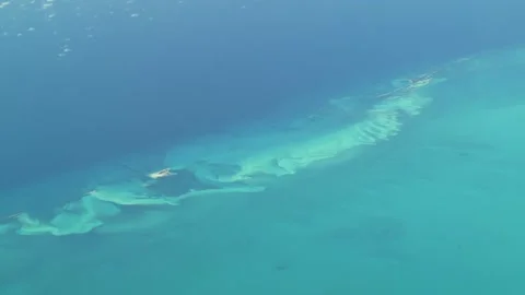 Flying over The Bahamas. Beautiful ocean colors. Actual aerial footage. Stock Footage 145376106