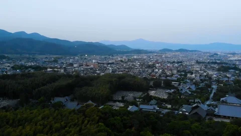 Flying over bamboo forest in the evening with a view over shrines and mountains Stock Footage 111888745