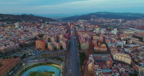 Flying over Barcelona at sunset, Spain. Streets and houses in street lights of 스톡 동영상 263707311