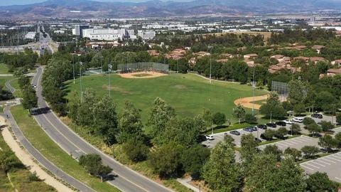 Flying over a baseball field with a little leaguge game going on Video stock 108760089