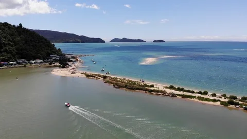 Flying over beach in summer toward the Abel Tasman National Park in New Zealand Stock Footage