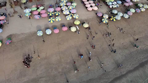 Flying over the beach with umbrellas Stock Footage 255637106