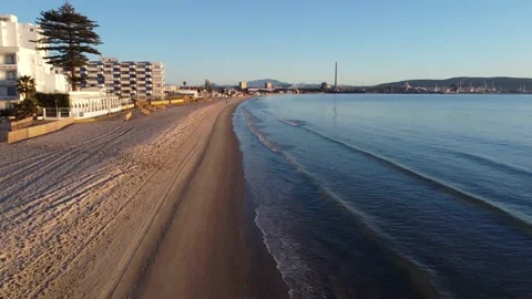 Flying over the beach at the very firs hour of the day with golden hour. Stock Footage