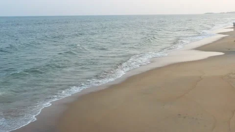 Flying over beach waves touching the coast 4k Stock Footage 234692062