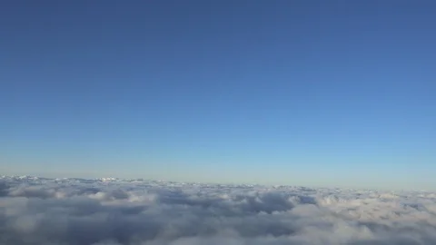 Flying over beautiful blue sky and flowing clouds. Aerial view from airplane. Stock Footage 93138059