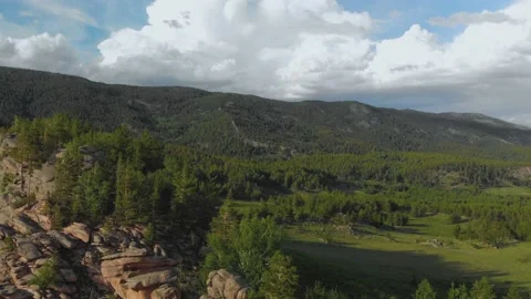 Flying over beautiful cliffs covered with coniferous forest 스톡 동영상 234795893