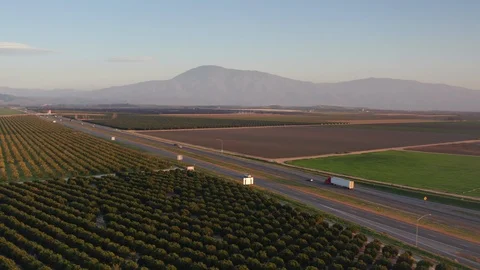 Flying over the beautiful farm fields of Bakersfield, California Stock Footage 125092111