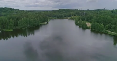 Flying over a beautiful forest lake on a summer day. Stock Footage 135477370