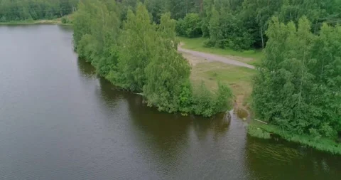 Flying over a beautiful forest lake on a summer day. Stock Footage 135477497