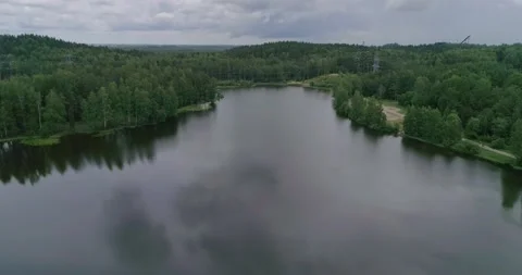 Flying over a beautiful forest lake on a summer day. Stock Footage 135477524