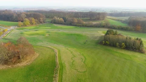 Flying over beautiful golf course in autumn sunlight, drone stock footage Stock Footage 140029069