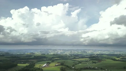 Flying over beautiful green fields with great clouds ahead. Video stock 234453857