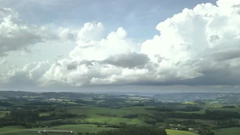 Flying over beautiful green fields with great clouds ahead. Video stock 234453951