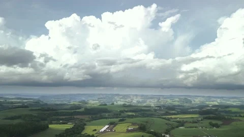 Flying over beautiful green fields with great clouds ahead. Stock Footage 234454164