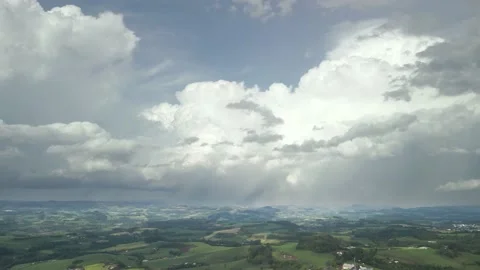 Flying over beautiful green fields with great clouds ahead. Video stock 234456788